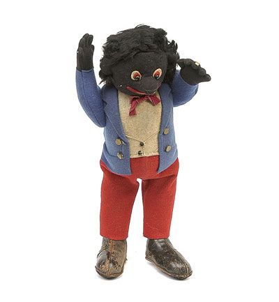 Vintage Steiff "Golliwog" doll wearing black leather shoes and red pants